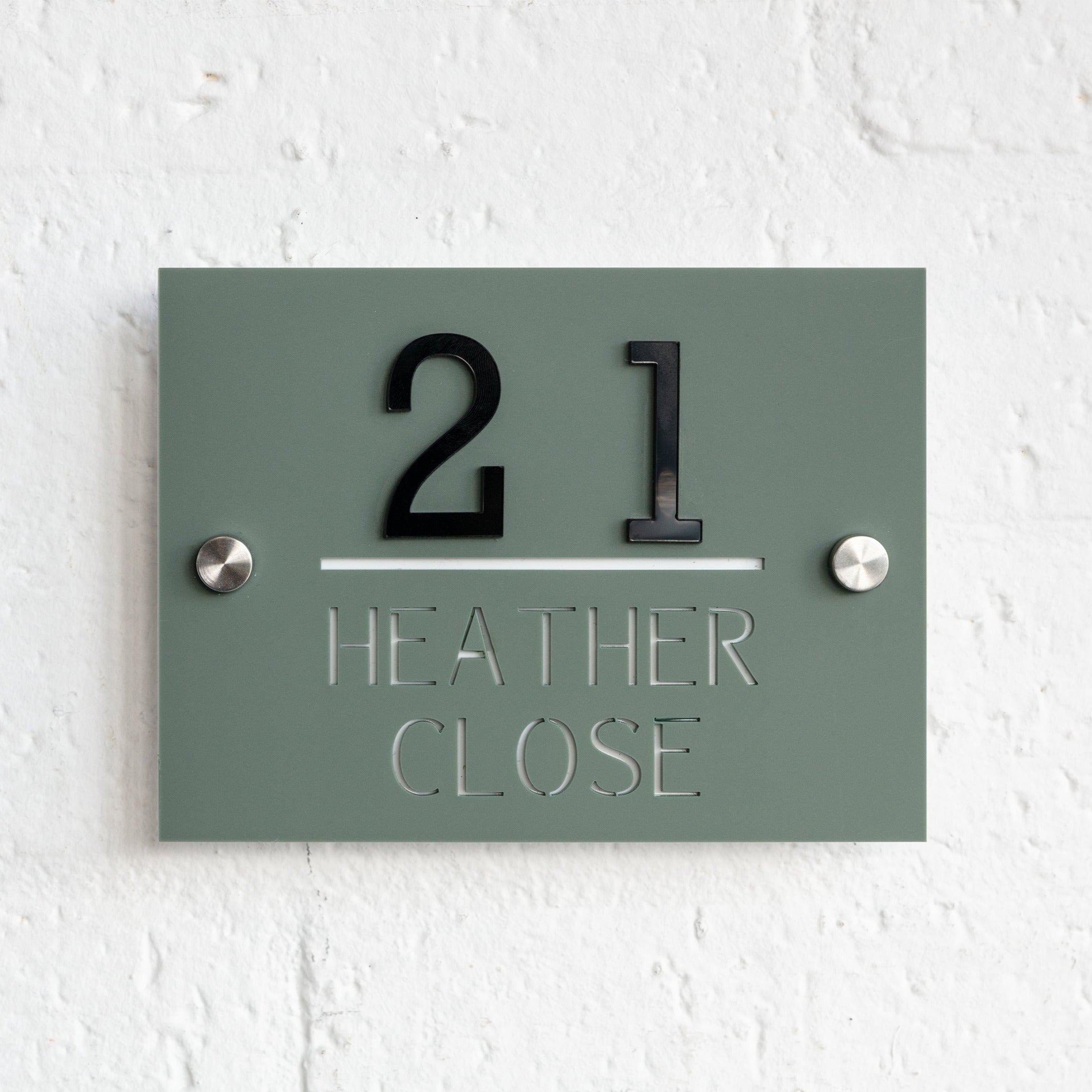 laser cut acrylic home door sign on white wall